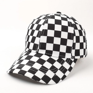 Close-up of black and white checkerboard pattern on the canvas baseball cap brim