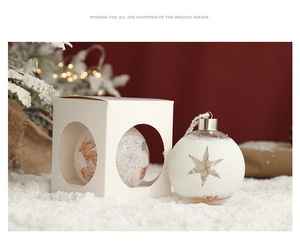 Detail of white star-patterned Christmas ornament with decorative matching gift box