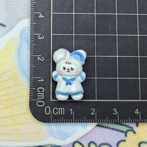 Detail showing 2cm resin bunny sailor figurine with ruler to demonstrate scale