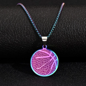 Macro detail of rainbow iridescent basketball pendant on textured black leather