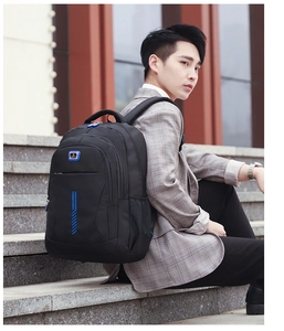 Detail of ergonomic padded straps and mesh side pocket on a black sports backpack