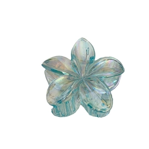 Iridescent light blue plumeria hair claw clip with colorful rainbow finish for women