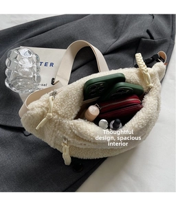 Spacious interior of white fleece crossbody bag holding phone, wallet and cosmetics