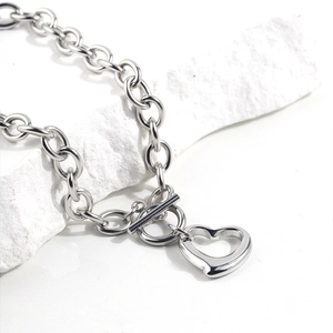 Detailed close-up of silver titanium steel heart necklace with T-bar toggle clasp