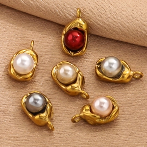 Detailed view of six gold-plated pea-shaped pendants with colorful pearl inlays