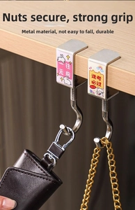 Detail of adjustable metal desk hook with cute rabbit pattern and screw-on clamp