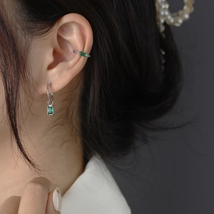 French design S925 silver C-shape earrings with emerald green zircon on female model