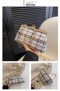 Close-up of elegant white sequin weave evening bag with crystal round handle and chain