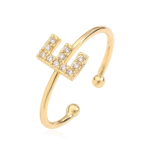 Close-up of gold plated copper ring featuring a cubic zirconia letter E alphabet design
