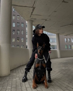 Street style detail of black hooded tracksuit set with embroidered sports cap