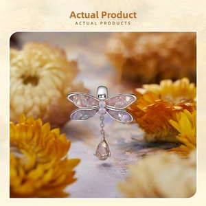 Exquisite silver dragonfly charm with purple crystals and pink teardrop pendant detail