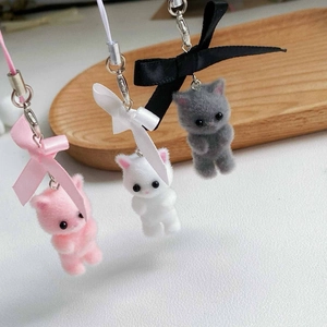 Close-up of cute flocked kittens with silk bows in pink, white, and grey colors