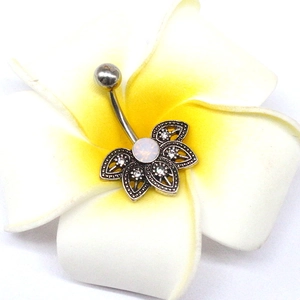 Silver lotus belly button ring with opal and crystals on a tropical flower