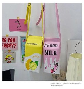 Detail of creative strawberry and lemonade milk box cross-body bags with PU leather texture