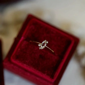 Detailed close-up of a marquise-cut crystal ring in a red velvet luxury jewelry box