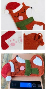 Detail of fox-shaped Christmas stocking showing paw prints and hanging loop material