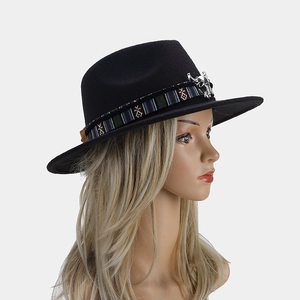 Détail du chapeau de laine noir avec bande ethnique tissée et ornement tête de taureau