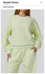 Detail view of lime green sweatshirt with white stripes on crew neck and cuffs