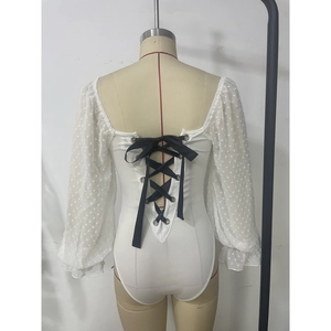 Detail of white mesh bodysuit with backless crisscross black ribbon tie closure