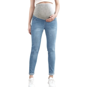 Detail of high-elasticity maternity waist band on slim fit light blue denim jeans