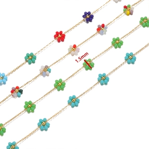 Detailed macro view of 1.5mm colorful flower beads on golden stainless steel chain