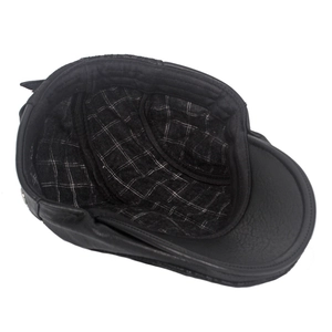 Detail view of winter leather flat cap showing the warm black and white checkered lining