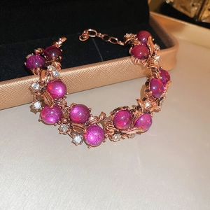 Detail of rose gold bracelet with purple gemstones and crystals in a luxury jewelry box