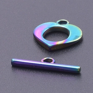 Macro detail of rainbow stainless steel OT toggle clasp with heart-shaped ring