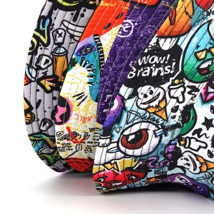 Close-up of graffiti bucket hat canvas texture with colorful cartoon pattern printing