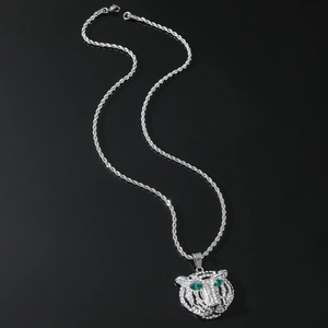 Macro view of hip hop lion head pendant with green crystal eyes and diamond accents