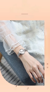 Detail of silver stainless steel watch with five-link bracelet and minimalist white dial