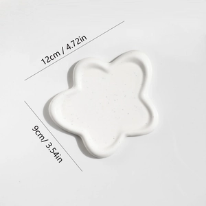 White flower shaped jewelry tray with black speckles and size dimensions 12cm by 9cm
