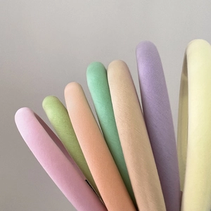 Close-up of colorful sponge headbands in soft macaron tones with textured fabric detail
