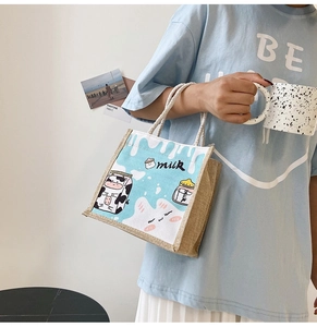 Close-up of cute cartoon milk pattern on textured linen handbag with white woven handle