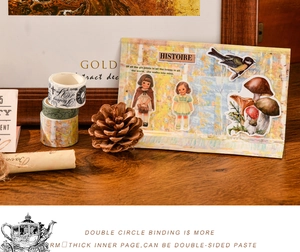 Close-up of vintage washi tape and stickers set on a rustic wooden desk with pine cones
