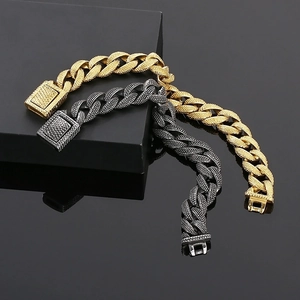 Detail of gold and silver cuban chain bracelets with granular texture and box clasp
