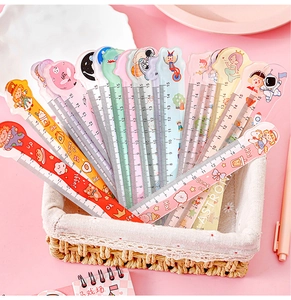 Close-up of colorful 15cm cartoon rulers in a white basket on a pink background