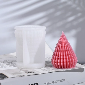 Macro detail of geometric Christmas tree silicone mold and finished pink textured candle