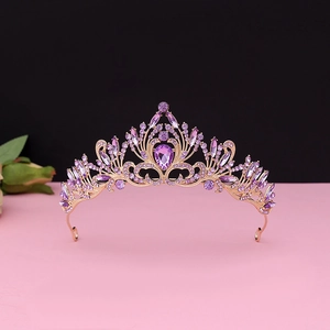 Detailed view of Baroque rose gold crown with inlaid purple crystals and pear-shaped gems