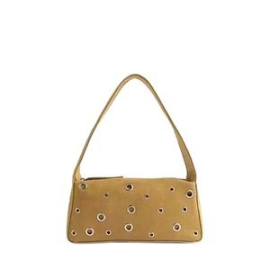 Vintage mustard suede underarm bag with decorative metal eyelets and rivets on white backdrop