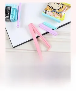Macro shot of colorful plastic food sealing clips for snack bags on wooden desk