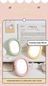 Detail of candy-colored wavy desktop mirrors in green, pink and yellow flower shapes
