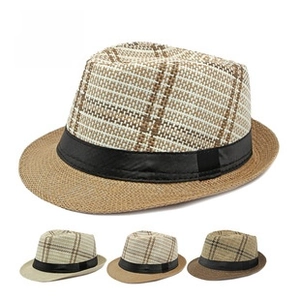 Detail of breathable straw fedora hats with coconut tree print and black ribbon band