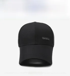 Front view of black baseball cap with extended brim and fashion label on cotton crown