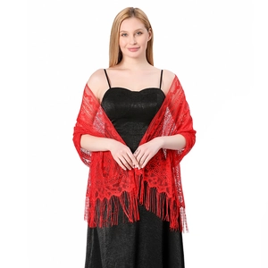 Macro detail of red lace shawl featuring intricate hollow patterns and delicate fringe trim