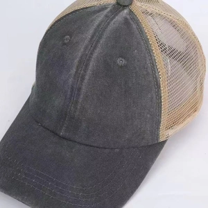 Detail of vintage washed grey trucker hat with breathable mesh and reinforced stitching