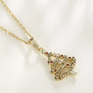Golden Christmas tree pendant necklace with colorful zircons on a white background