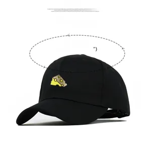 Detailed view of yellow cheese embroidery on black cotton baseball cap with adjustable strap