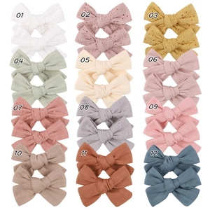 Detailed set of 24 baby lace bows in various colors and textures for newborns