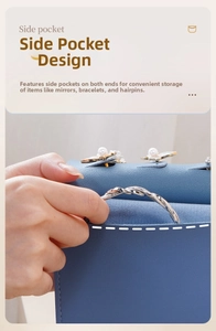 Close-up of hand placing a bracelet into the side pocket of a blue leather jewelry pouch